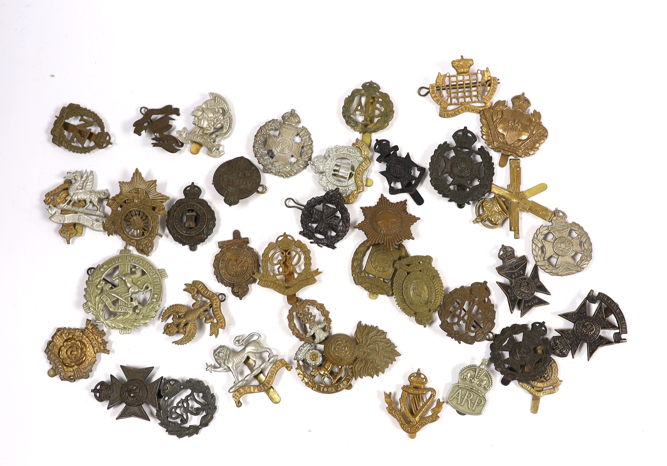Forty military cap badges including City of London Cyclists, Lincolnshire Yeomanry, Connaught Rangers, The County of London, Royal Gloucestershire Hussars, NAAFI, Military Police, the Rangers, Sussex Yeomanry, Lanarkshir